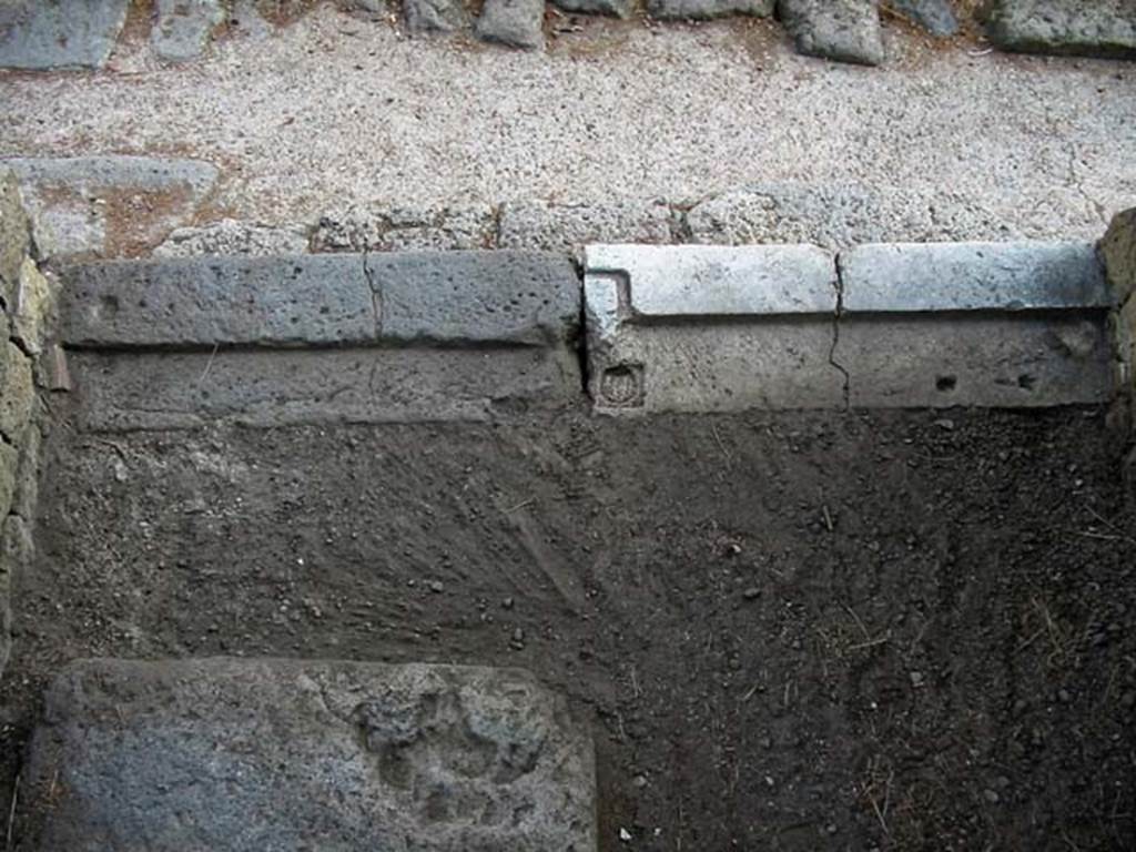 V.33, Herculaneum. May 2003. Looking east to threshold of entrance doorway.
In the lower part of the photo, the base step to the upper floor is visible. Photo courtesy of Nicolas Monteix.